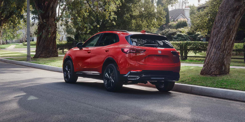 Red Buick Envision parked on a suburban street.